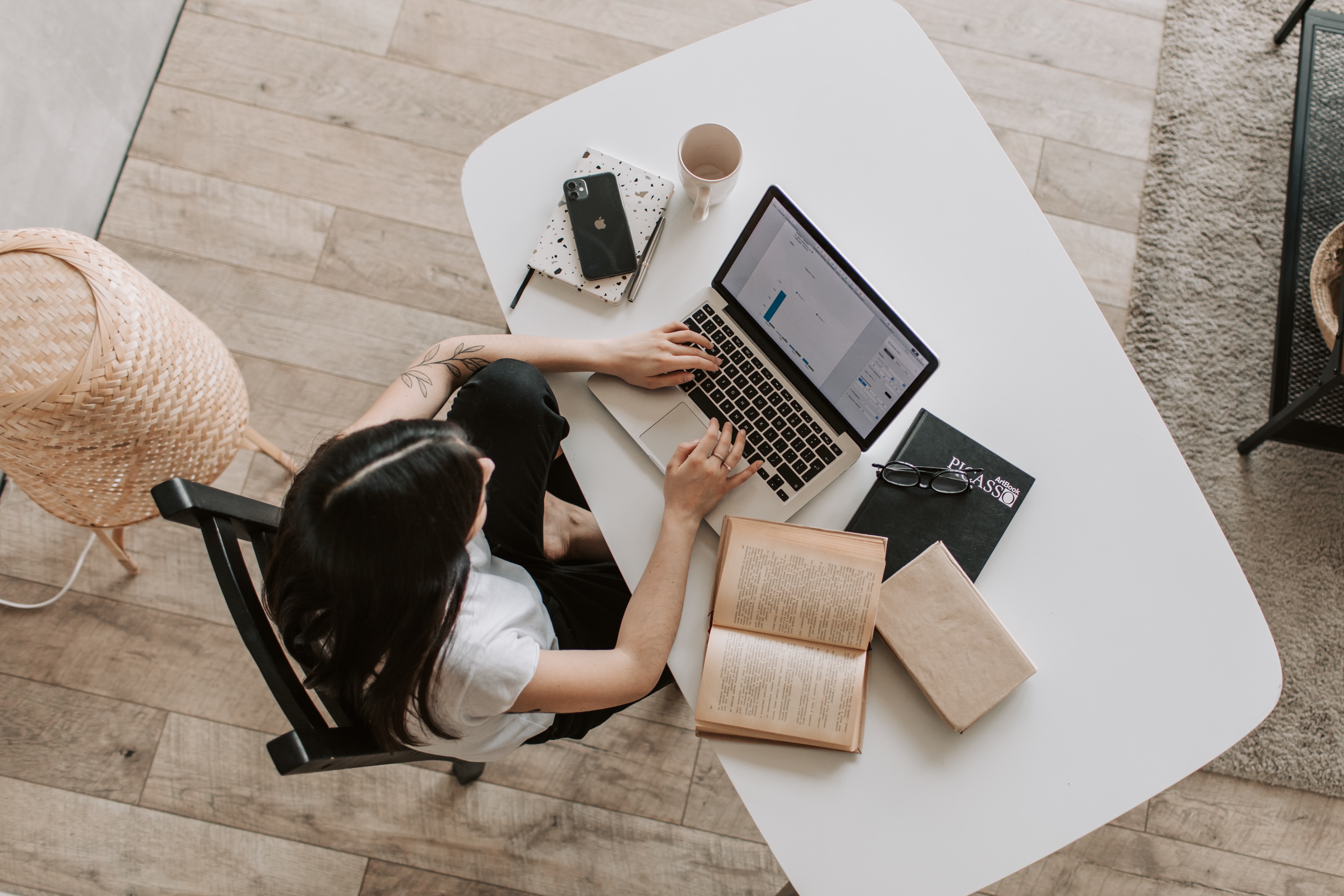 woman sitting at laptop typing